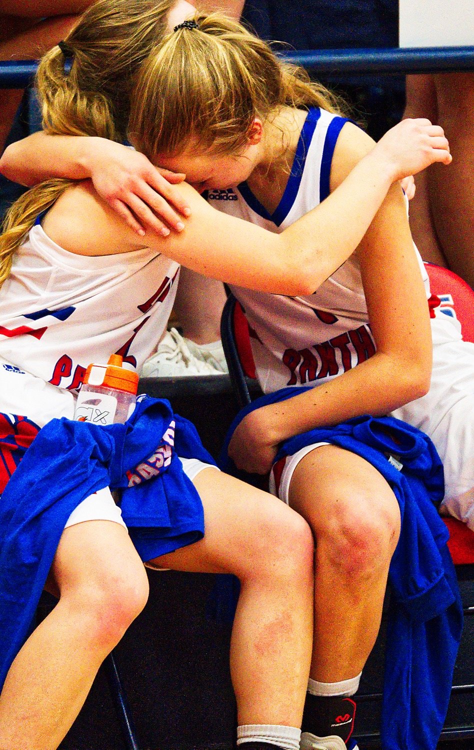 Were there any doubt in one's mind whether the Lady Panthers care about the game of basketball, looking to their bench in the closing minute of play should cast it out. Here, Cacie Lennon and Bella Crawford console one another. [see more shots, score prints]